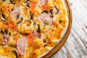 delicious hot traditional italian pizza on a white wooden rustic background