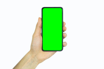 Hand holding mobile phone with green screen, advertising concept, smartphone for promotion and banner, front view of mobile phone, showing empty screen of cellphone, copy space