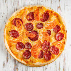 delicious hot traditional italian pizza on a white wooden rustic background