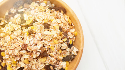 sunrise muesli on a white wooden table. muesli top view
