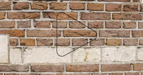 Image of glowing neon arrow icon on brick wall