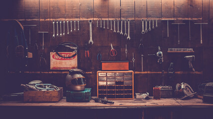 Workshop scene. Old tools hanging on wall in workshop, Tool shelf against a table and wall, vintage garage style - obrazy, fototapety, plakaty