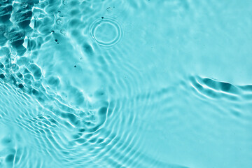 Trendy summer nature banner. Defocused aqua-mint liquid colored clear water surface texture with splashes bubbles with copy space. Water waves in sunlight background.	