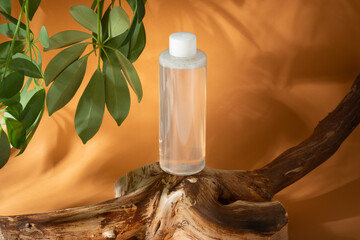 micellar water, tonic on orange white background