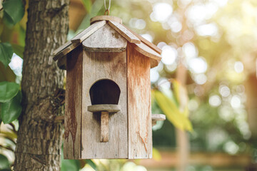 birdhouse. wood bird home house box at tree in the garden