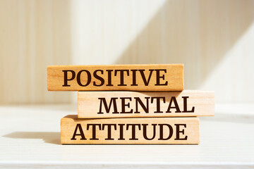 Wooden blocks with words 'Positive Mental Attitude'.