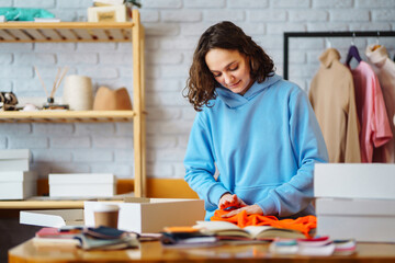 Preparing a parcel on the table. Оnline store, small business owner, seller, entrepreneur, packing bag, mailbox, preparing a parcel on the table. Dropshipping delivery concept in e-commerce.