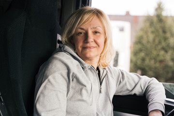 Caucasian mid age woman driving truck. trucker female worker, transport industry occupation 