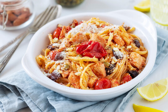 Linguine or spaghetti with swordfish, fresh cherry tomatoes, olives and capers sprinkled with grated cheese