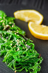 fresh delicious Chukka Wakame salad on a black wooden rustic background