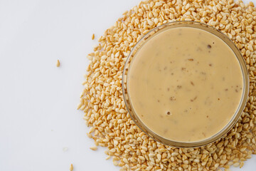 sesame tahini paste on a white acrylic background