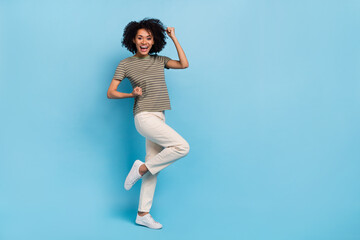 Full length photo of delighted lady rejoicing fist up win lottery isolated on blue color background