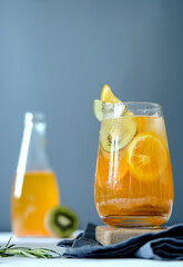 Fruit lemonade. Orange lemonade. Kiwi lemonade. Summer lemonade. Lemonade on a wooden board.