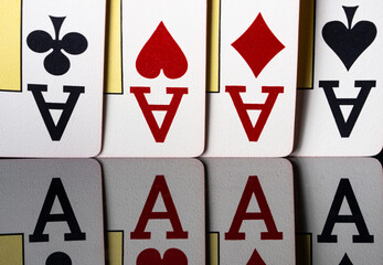Obraz premium A combination of playing cards of four aces on a reflective surface. Cards for playing poker, blackjack or texas holdem close up. The concept of gambling, casino entertainment, betting and success.