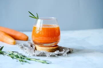 Foto auf Acrylglas Carrot juice in a glassy glass. Freshly lived carrot juice. Orange carrot juice. Vegetable juice © Kristina