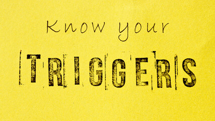 Know your triggers sign message on yellow background. Mental triggering and self-awareness concept.