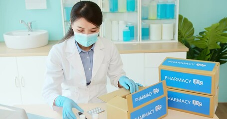 asian pharmacist pack medication