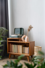 Retro style vinyl player and antique home decor in room