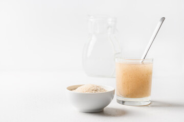 Psyllium husk and glass of water soluble fiber supplement for intestinal on white background....