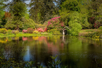 Obraz premium Scenic view of a lake and boathouse in a private large garden