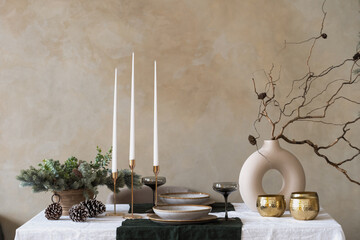 Table setting with natural decorations, tableware, cutlery and glassware