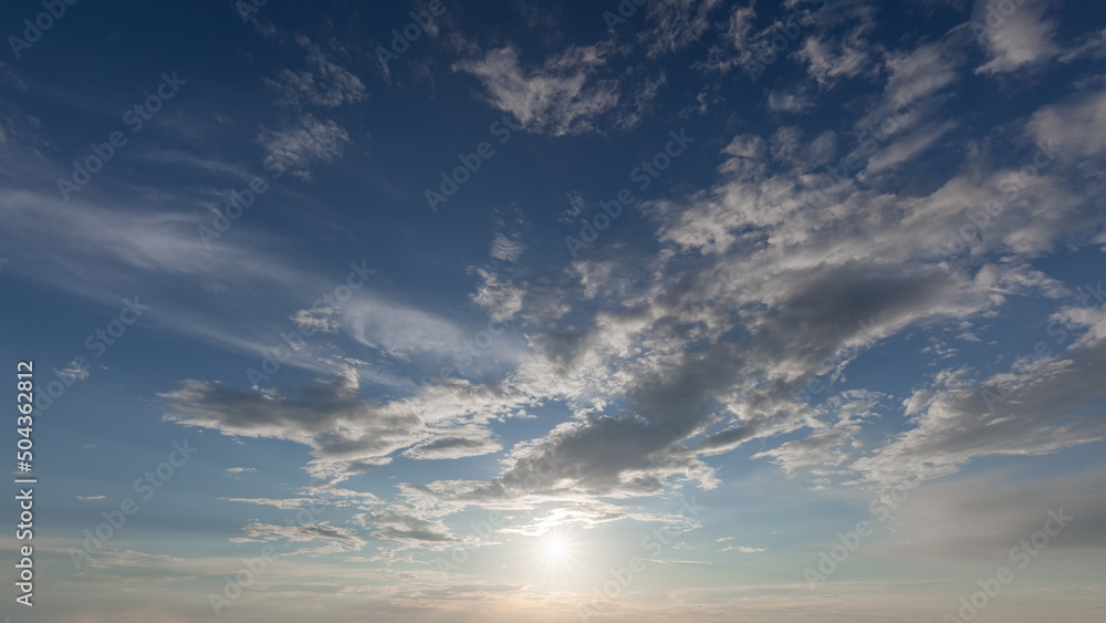 Wall mural blue sky with clouds with sun in counter light