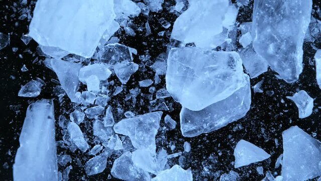 Super slow motion of falling piece of ice on black background. Filmed on high speed cinema camera, 1000 fps.