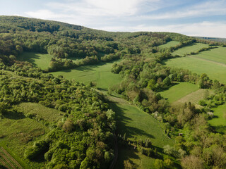 Fototapeta na wymiar aerial drone flight over green meadows and forest in lower austria