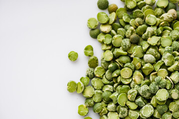 dried green peas on a white acrylic background