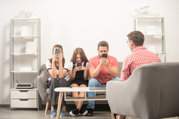 kid with phone addicted daddy and mom sitting at psychologist solving problem, internet