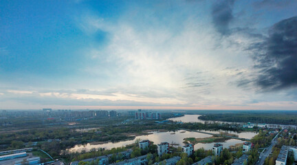 Fototapeta na wymiar aerial view of suburb of Sanit-Petersburg at sunset. panorama of the city with beautiful lakes and Neva river on the background.