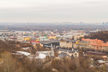 Ukraine, Kyiv – November 26, 2016: Aerial panoramic view on central and historical part of Kyiv city, residential area in the evening. St Andrew's Church, Podil area.