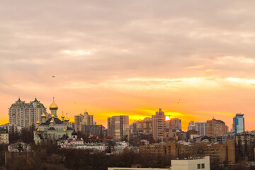Ukraine, Kyiv – November 26, 2016: Aerial panoramic view on central part of Kyiv city, residential area at sunset. Stunning sunset, golden hour. Lukianivska area. City silhouettes. 