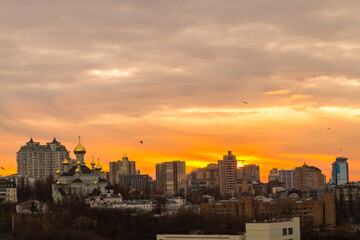 Fototapeta na wymiar Ukraine, Kyiv – November 26, 2016: Aerial panoramic view on central part of Kyiv city, residential area at sunset. Stunning sunset, golden hour. Lukianivska area. City silhouettes. 