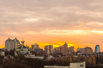 Fototapeta premium Ukraine, Kyiv – November 26, 2016: Aerial panoramic view on central part of Kyiv city, residential area at sunset. Stunning sunset, golden hour. Lukianivska area. City silhouettes. 