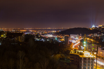 Fototapeta premium Ukraine, Kyiv – November 26, 2016: Aerial panoramic view on central and historical part of Kyiv city, residential area in the evening. St Andrew's Church, Podil area.