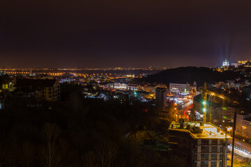 Fototapeta premium Ukraine, Kyiv – November 26, 2016: Aerial panoramic view on central and historical part of Kyiv city, residential area in the evening. St Andrew's Church, Podil area.
