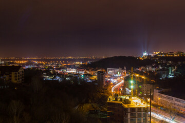 Fototapeta premium Ukraine, Kyiv – November 26, 2016: Aerial panoramic view on central and historical part of Kyiv city, residential area in the evening. St Andrew's Church, Podil area.