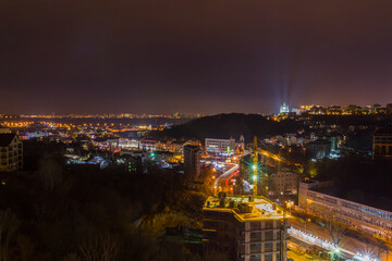 Fototapeta premium Ukraine, Kyiv – November 26, 2016: Aerial panoramic view on central and historical part of Kyiv city, residential area in the evening. St Andrew's Church, Podil area.