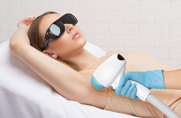 Elos epilation hair removal procedure on a woman’s body. Beautician doing laser rejuvenation in a...