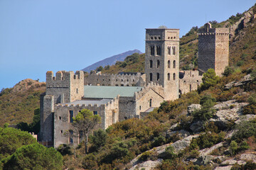 The romanesque monastery of Sant Pere de Rodes with its bell tower on a mountain slope in...
