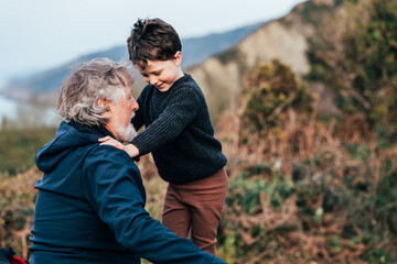 grandfather playing with his grandson outdoors
