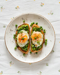 Toasts with green peas and eggs on a concrete background. Homemade healthy pea toast