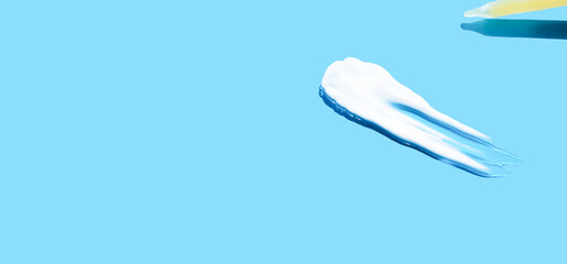 Pipette with dose of fluid hyaluronic acid on blue background. cosmetic concept. flat lay. 