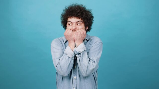 Suspicious bearded man looks to sides getting scared