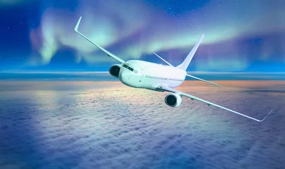 Fototapeten Northern Lights (Aurora Borealis) with commercial passenger airplane © muratart