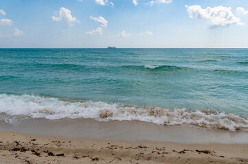 sea wave water and beach with ship on horizon