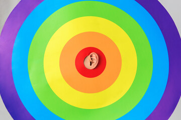 the ear sticks out of the rainbow target, concept of LGBTQ pride, LGBTQ people, LGBTQ rights campaign