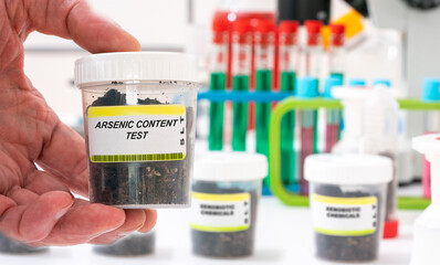 Arsenic. Arsenic content in soil sample in plastic container. Study of agricultural soil in a chemical laboratory