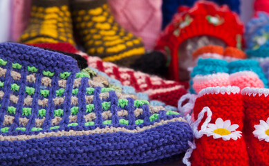 Handmade multi-colored knitted things close-up.